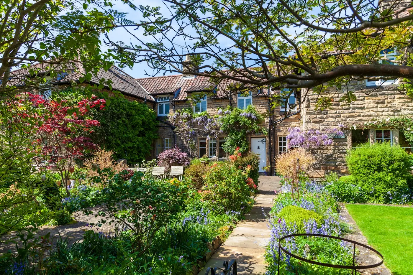 Cottage garden with lawn and deep planted borders