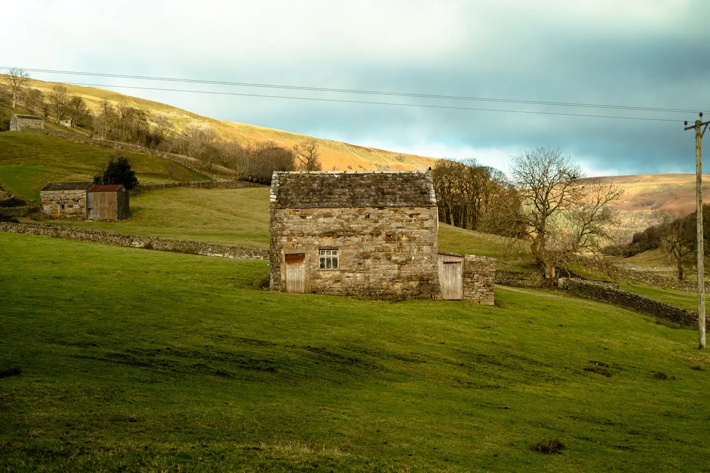 Stone farmhouse on a green Yorkshire hillside