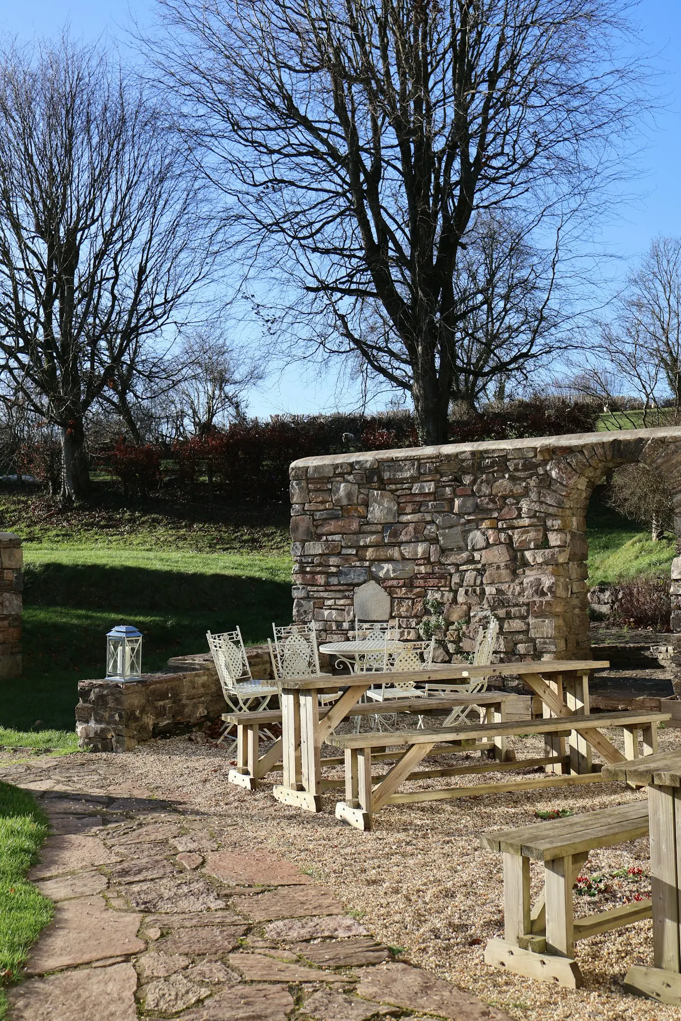 Stone patio enclosed by a low stone wall